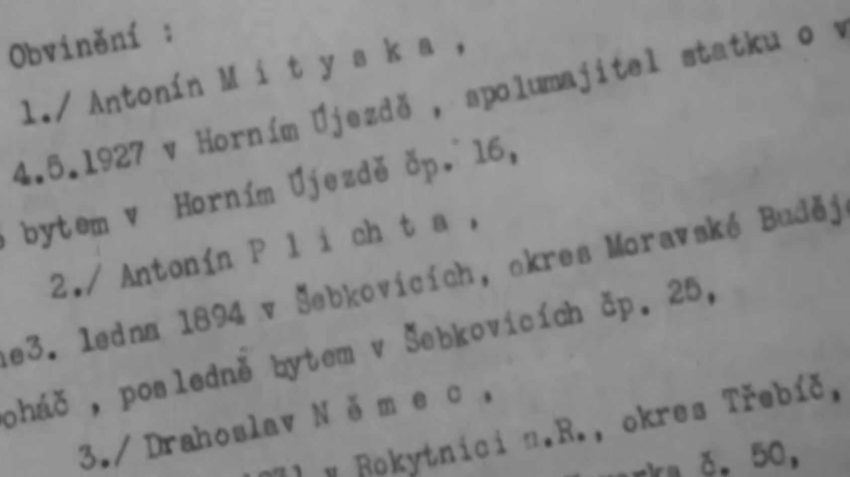 A typed Czech charge sheet headed Obvineni, the accusation, numbering Antonin Mityska, Antonin Plichta and Drahoslav Nemec with their birth dates and home villages