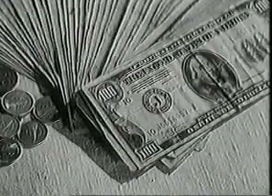 A black and white evidence photograph of a fan of hundred dollar bills and a scatter of coins laid out on a table