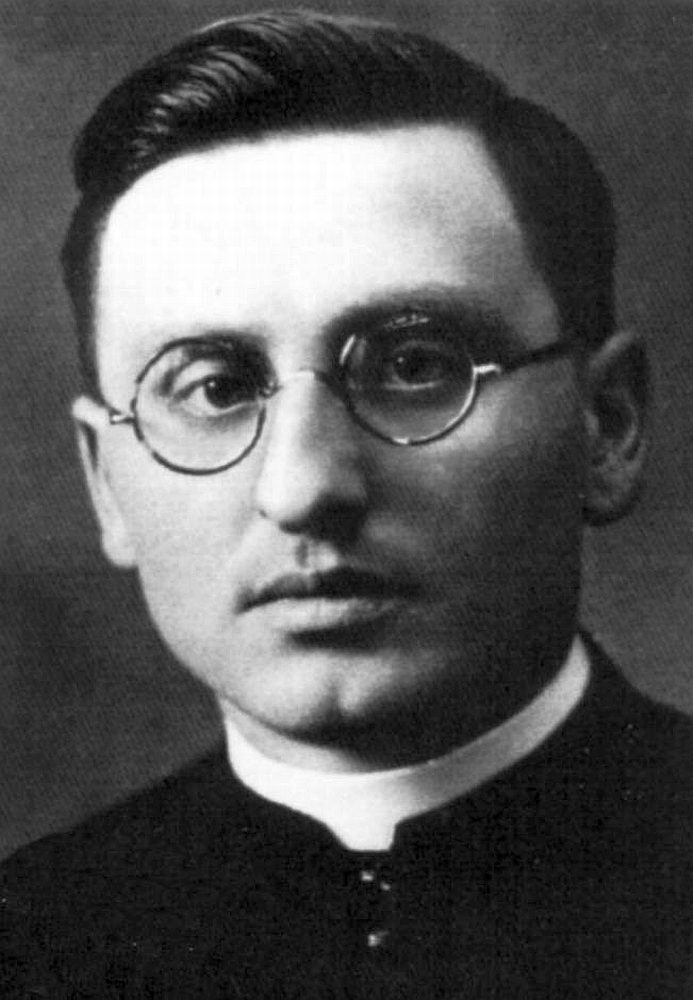 Frantisek Paril, black and white head and shoulders portrait of a priest in round wire spectacles and a Roman collar