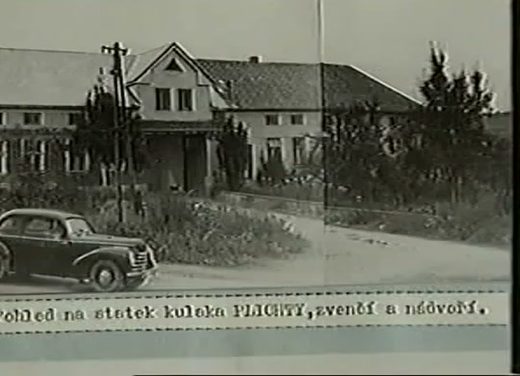 A period photograph of a long farmhouse and outbuildings behind a fence with a car on the road in front, a typed caption pasted beneath reading a view of the kulak Plichta's farm, from outside and the yard
