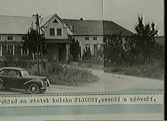 A period photograph of a long farmhouse and outbuildings behind a fence with a car on the road in front, a typed caption pasted beneath reading a view of the kulak Plichta's farm, from outside and the yard