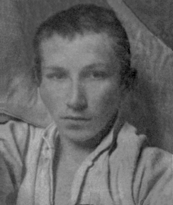Stanislav Plichta, grainy black and white photograph of a young man lying propped against a pillow in a light shirt