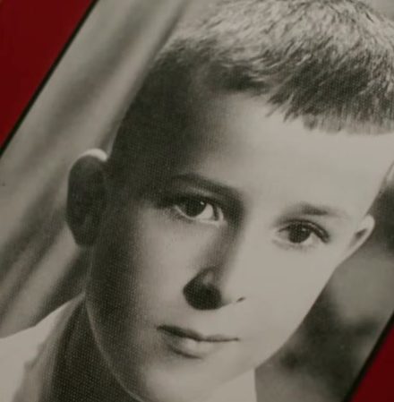 A black and white studio portrait of a small boy, from a family album