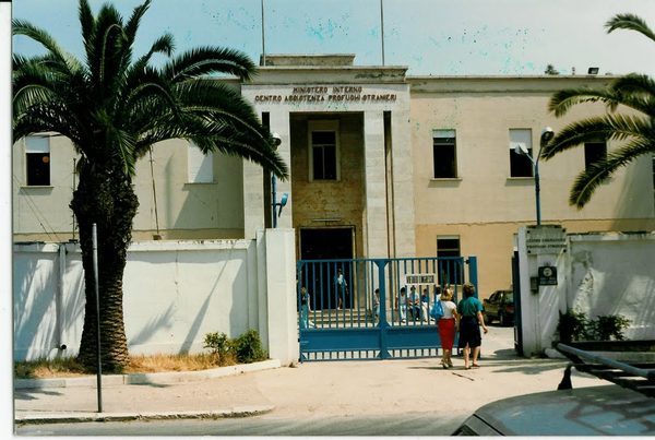 The gate and entrance road of the refugee camp at Latina, south of Rome