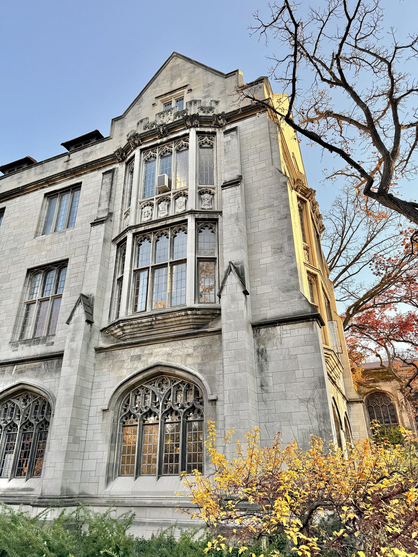 The gothic stone facade of Swift Hall at the University of Chicago, with arched windows and a pitched roof