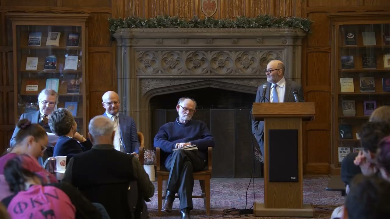 A panel seated in a wood panelled hall inside Swift Hall during a Divinity School forum