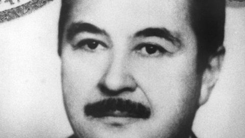 A grainy black and white identity portrait of Stjepan Đureković facing the camera, dark hair combed back and a heavy moustache, part of an official stamp visible at the top left corner