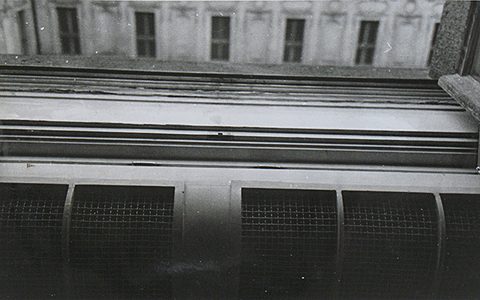 A view out and down from the bathroom window on 10 March 1948 onto the stone cornice that runs the length of the facade, with the windows of the opposite wing above it