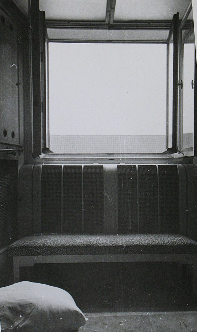 The bathroom window of Jan Masaryk's flat photographed from inside on 10 March 1948: the casement open outward, the bench beneath it, a pillow on the floor