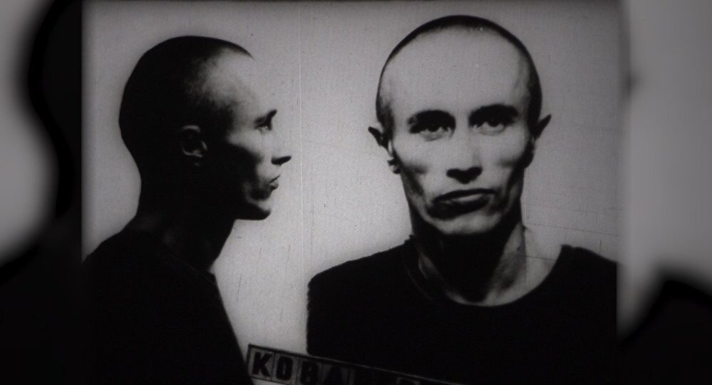 A prison identification photograph of a young man with a shaven head, shown in profile and full face, with a name board across the bottom of the frame