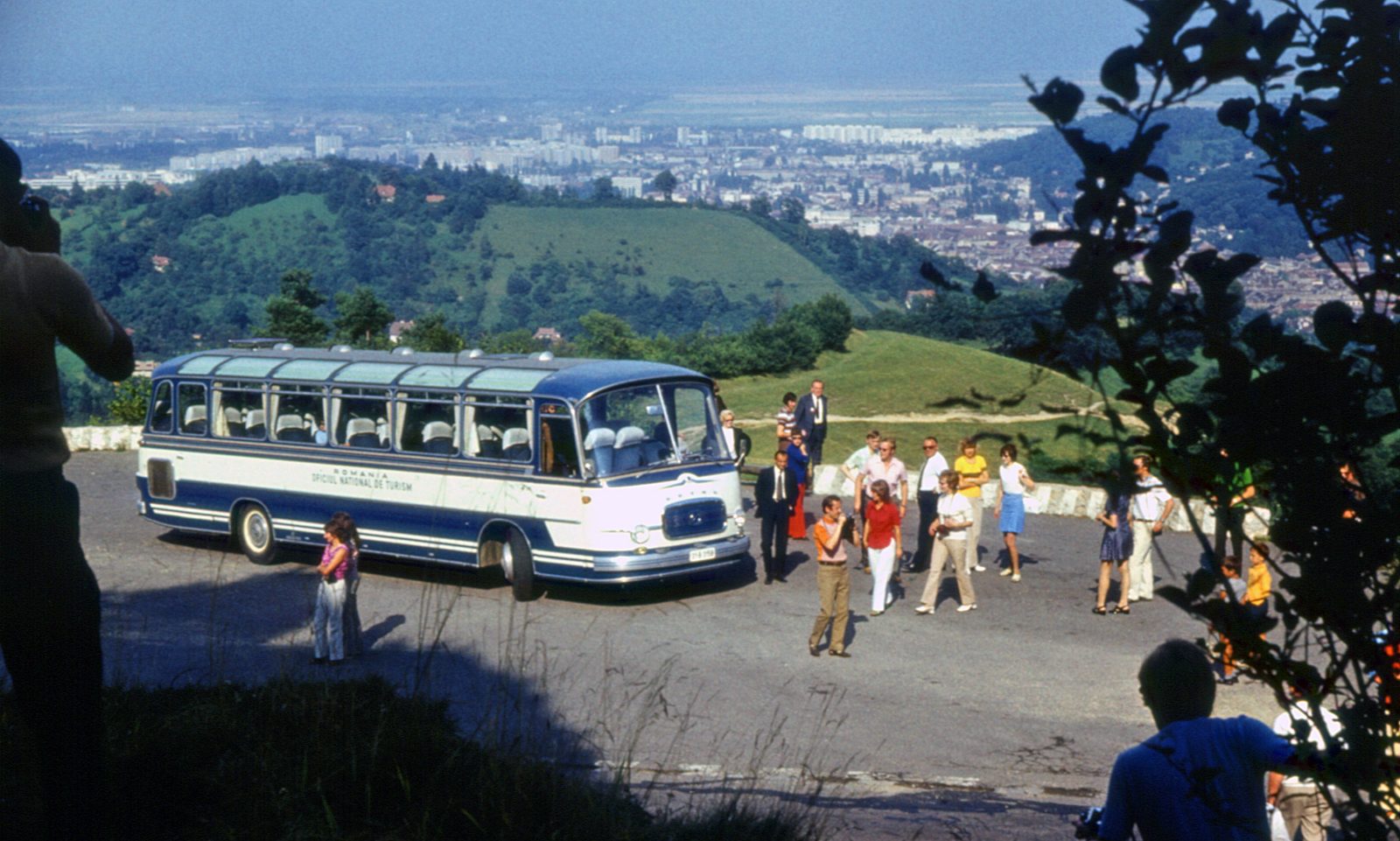 A tour bus carrying a group of young tourists on the mountain road up to Poiana Brașov in August 1973