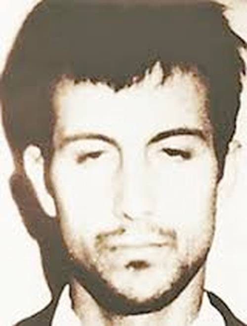 Ion Rîmaru, a young man with dark hair and a few days of stubble, photographed face on against a plain wall