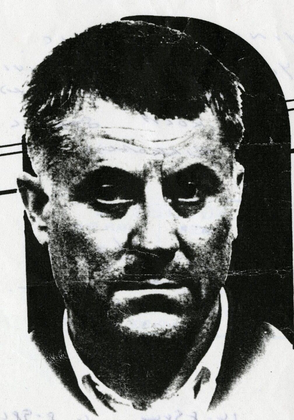 A high contrast newspaper halftone of a man's head and shoulders in shirt and tie, cut out for printing, with crop lines ruled across the print