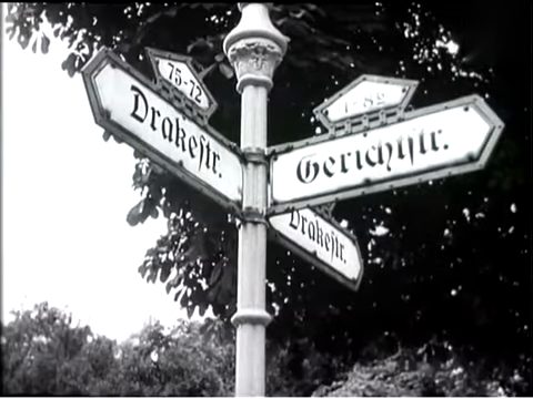 A newsreel frame of the Gerichtsstrasse street sign in Berlin-Lichterfelde, filmed in July 1952